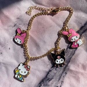 Handmade Sanrio gold charm bracelet featuring Hello Kitty, My Melody, and Kuromi